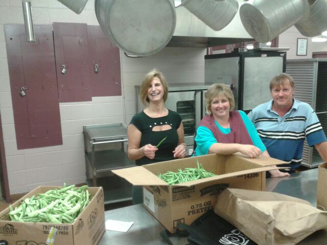 Ithaca City School District Central Kitchen employees with locally grown green beans